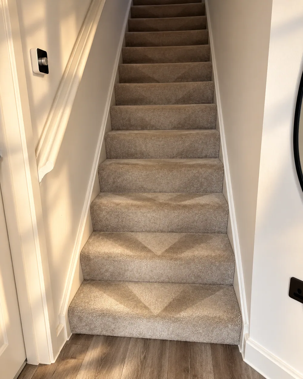 Edited campaign photograph of the closed staircase with neatly groomed chevron patterns in the carpet pile